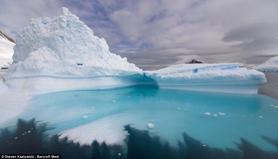 Ice pool: The incredible blue water thaat surrounds this striking iceberg  Read more: http://www.dailymail.co.uk/news/worldnews/article-1258041/Incredible-pictures-giant-ice-sculptures-carved-sea-water-polar-winds.html#ixzz0kwchCzo5