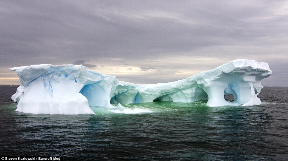 This iceberg floating off the Western Antarctic peninsula has been carved into a bridge by the sea and polar winds  Read more: http://www.dailymail.co.uk/news/worldnews/article-1258041/Incredible-pictures-giant-ice-sculptures-carved-sea-water-polar-winds.html#ixzz0kwcpZgHz