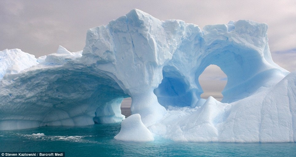 The power of sea has bored holes through this iceberg creating vast arches in the ice  Read more: http://www.dailymail.co.uk/news/worldnews/article-1258041/Incredible-pictures-giant-ice-sculptures-carved-sea-water-polar-winds.html#ixzz0kwdCGdNY