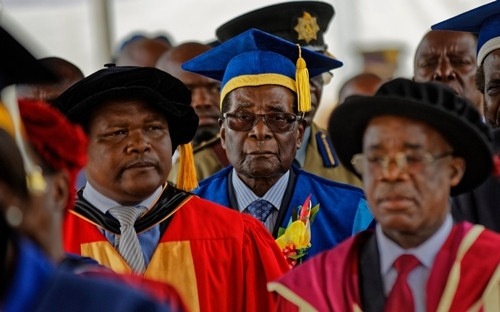 Zimbabwes President Robert Mugabe, center, arrives to preside over a student graduation ceremony at Zimbabwe Open University on the outskirts of Harare, Zimbabwe  CREDIT: AP