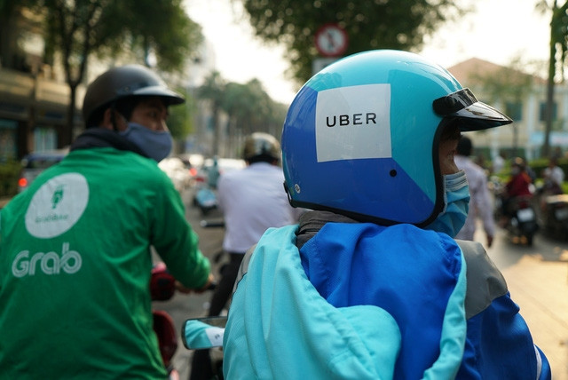 Grab mua lại toàn bộ Uber Đông Nam Á - Ảnh 1.