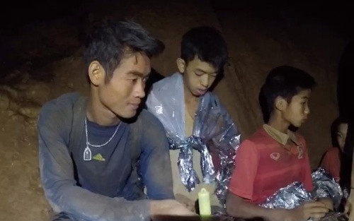 Ekkapol Chantawong (left)  is among the last 3 including 2 boys to be escorted by divers out of flooded