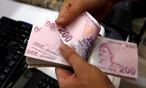 Nhân viên kiểm tiền tại một quầy đổi ngoại tệ ở Istanbul. Ảnh: Reuters
