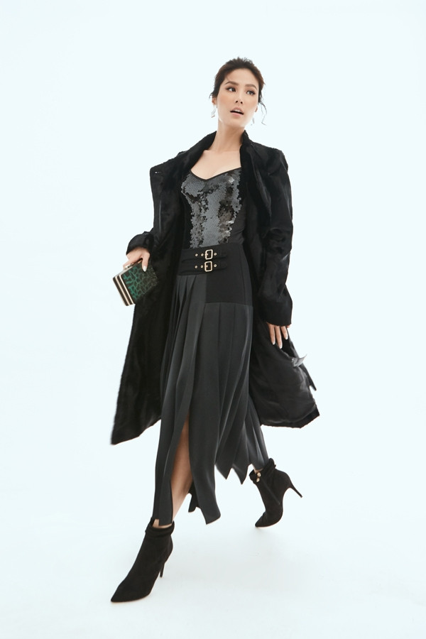 Nhà mốt Karen Millen cũng đã rất tinh tế khi kết hợp áo sequin lấp lánh cùng chân váy dài xẻ tà tua rua táo bạo, tạo nên một tổng thể trang phục độc đáo và cũng vô cùng ấm áp khi mix áo khoác dài cùng tông đen thời thượng