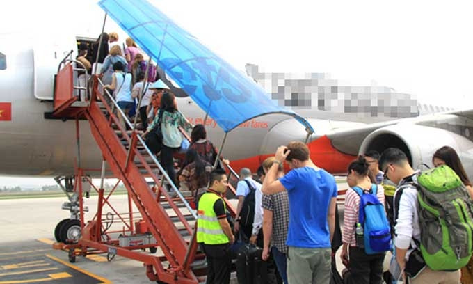 Hành khách lên máy bay tại sân bay Nội Bài.
