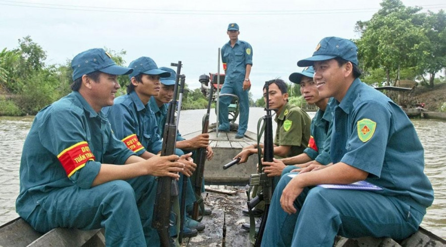 Chiến sĩ dân quân Nguyễn Văn Thuận (bên trái) tham gia tuần tra bảo vệ an toàn địa bàn.