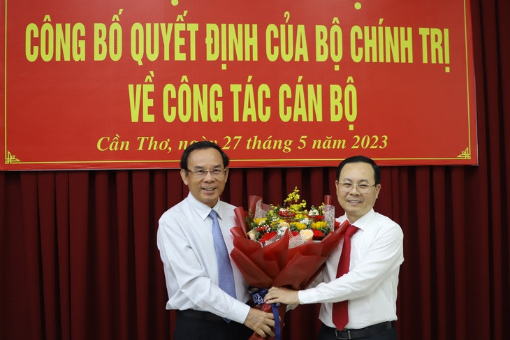 Bí thư Thành ủy TP.HCM Nguyễn Văn Nên (trái) tặng hoa chúc mừng tân Bí thư Thành ủy Cần Thơ Nguyễn Văn Hiếu - Ảnh: CHÍ QUỐC