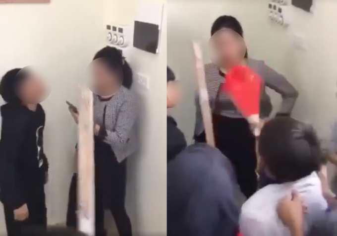 Cô giáo bị dồn vào góc tường, học sinh liên tục chửi bới, dùng gậy và quạt chỉ vào mặt cô. Ảnh cắt từ clip