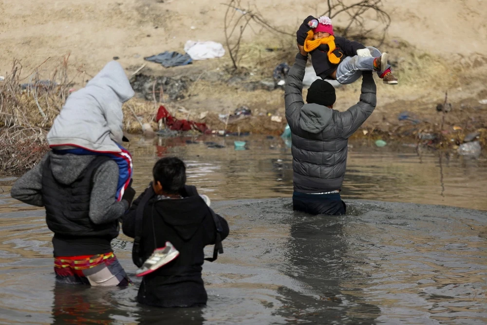 Người di cư vượt sông để vào Mỹ tại Ciudad Juarez, bang Chihuahua, Mexico, ngày 2/1/2024. (Ảnh: AFP/TTXVN)