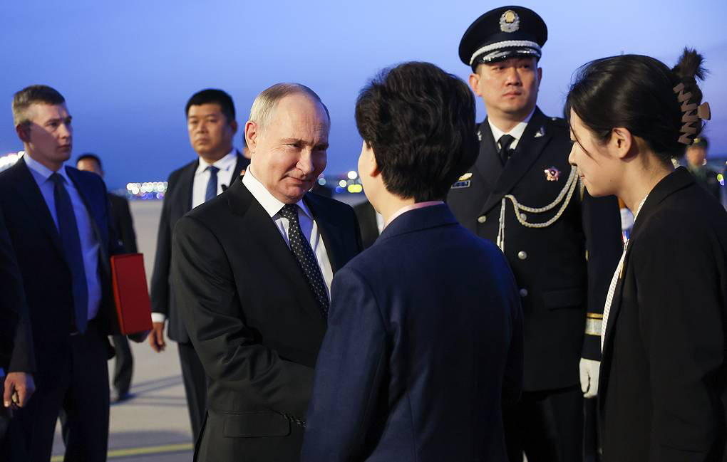 Ông Putin bắt tay Ủy viên Quốc vụ viện Thầm Di Cầm sau khi tới Trung Quốc - Ảnh: TASS