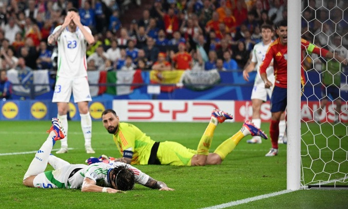 Riccardo Calafiori (L) lies on the ground after scoring an own goal in Italys 0-1 loss to Spain at Euro 2024, June 21, 2024. Photo by Reuters