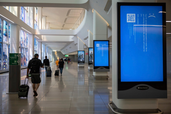 Screens show a blue error message at a departure floor of LaGuardia Airport in New York on Friday, July 19, 2024, after a faulty CrowdStrike update caused a major internet outage for computers running Microsoft Windows. (AP Photo/Yuki Iwamura)