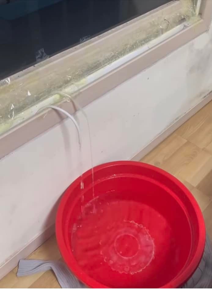 A water pouring into a red bucketDescription automatically generated