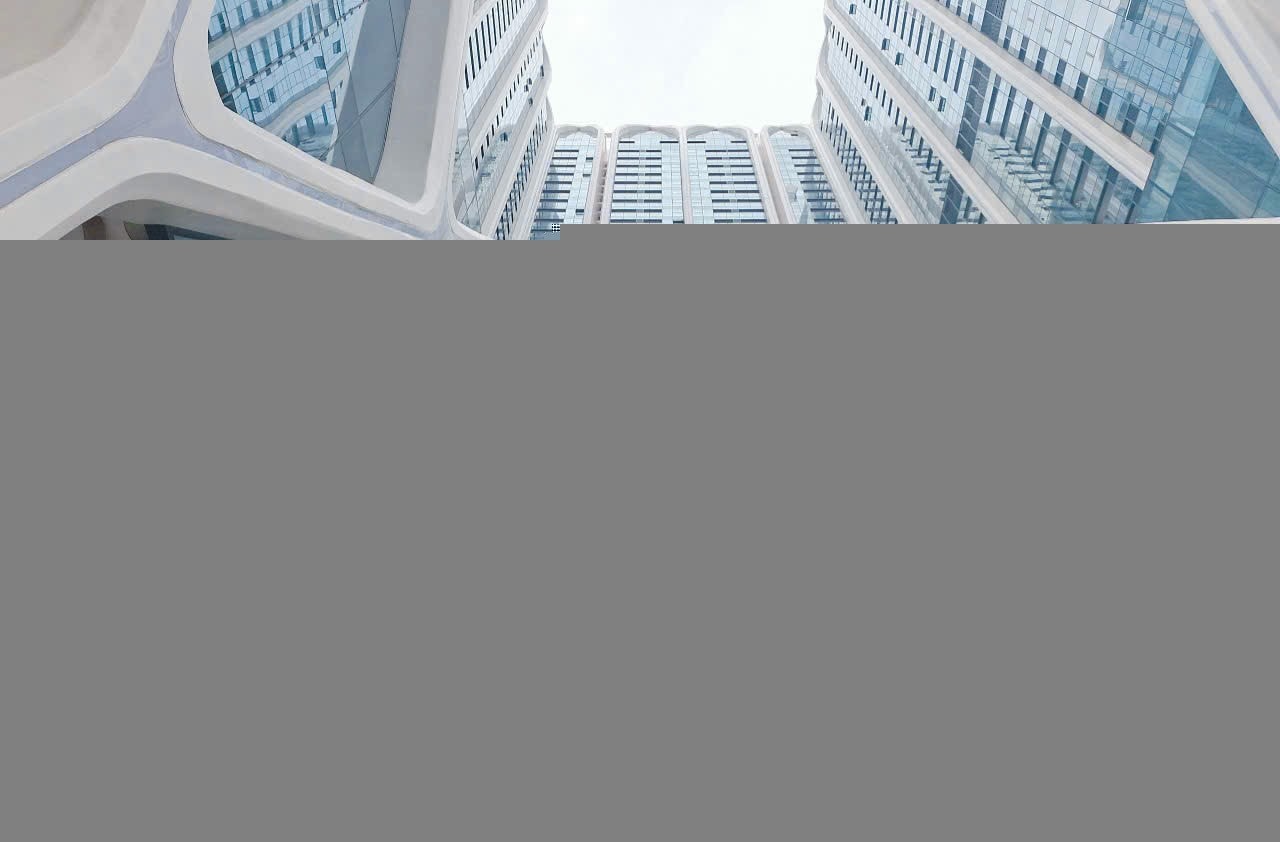 Looking up view of a tall buildingDescription automatically generated