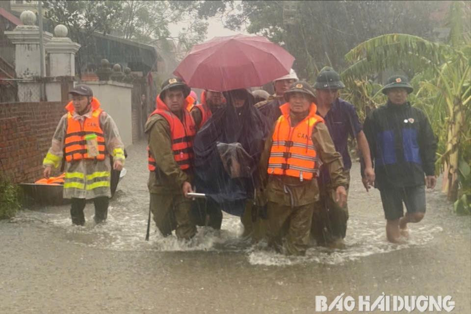 Các lực lượng hỗ trợ đưa những người già, sức khỏe yếu ở thôn Mỹ Xá (Minh Tân, Nam Sách) đến nơi an toàn