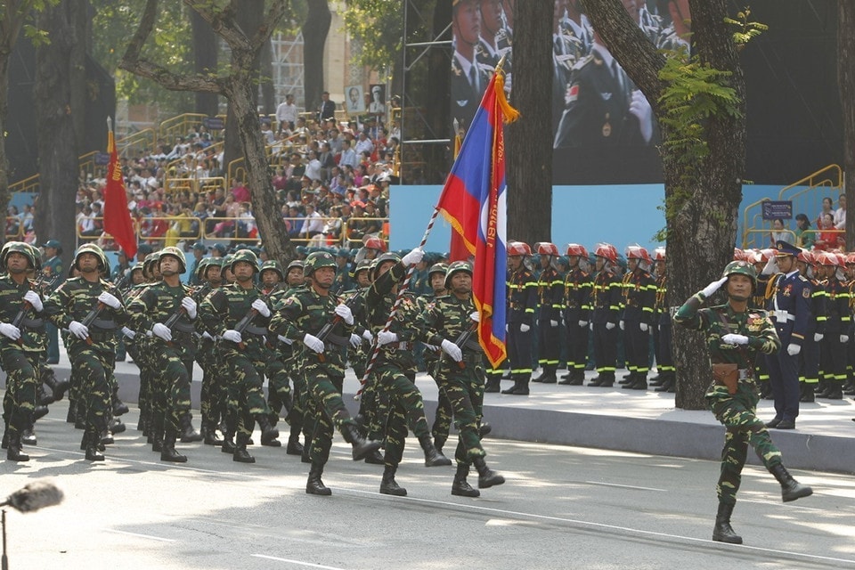 The Lao People's Army marches past the grandstand. Photo: VNA