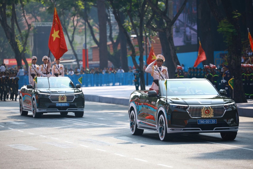 The command vehicle and vehicles of the People's Police Force parade past the grandstand Photo: VNA