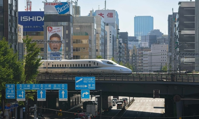 Một tàu shinkanshen (Nhật Bản) đi qua đường phố Tokyo. Ảnh: AFP