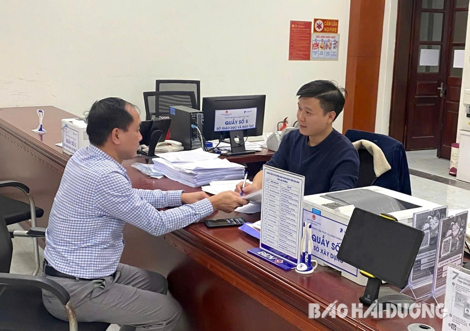 Nhiều thủ tục hành chính thuộc Sở Xây dựng đã và đang được cắt giảm, giúp doanh nghiệp giảm bớt nhiều chi phí. Trong ảnh: Công chức Sở Xây dựng trả kết quả cho người dân tại Trung tâm Phục vụ hành chính công tỉnh