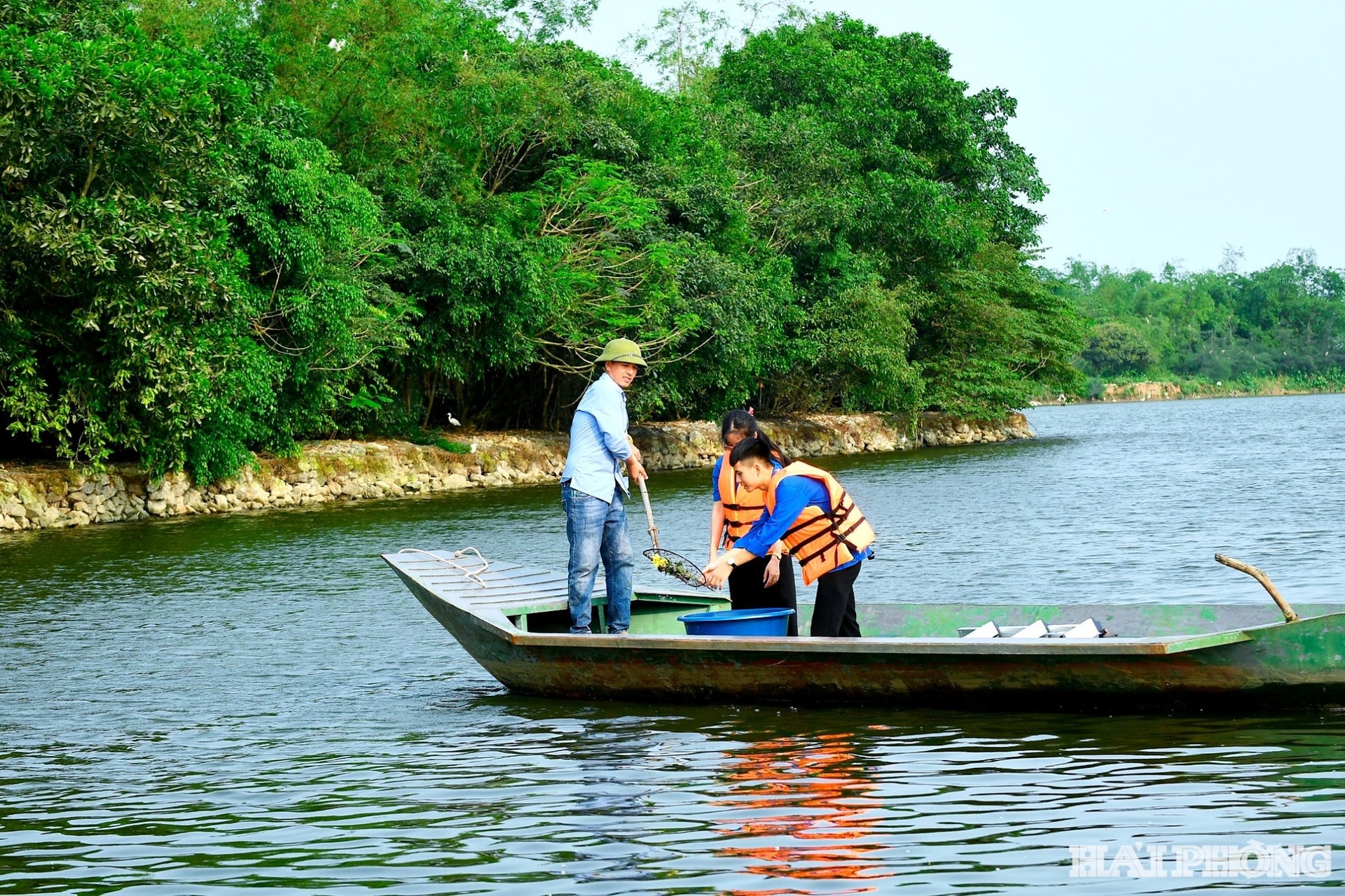 Đội tự quản an ninh trật tự Đảo Cò và Đoàn Thanh niên xã vớt rác tại khu vực lòng hồ An Dương. ẢNH: THÀNH CHUNG