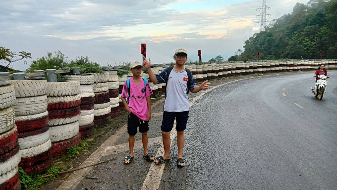 Hai con trai Bình An (áo hồng), Bảo An (áo trắng), cùng 13 tuổi chụp ảnh trên đèo Nà Lơi, Điện Biên, trên đường di chuyển về Hà Nội, ngày 15/8. Ảnh: Nhân vật cung cấp