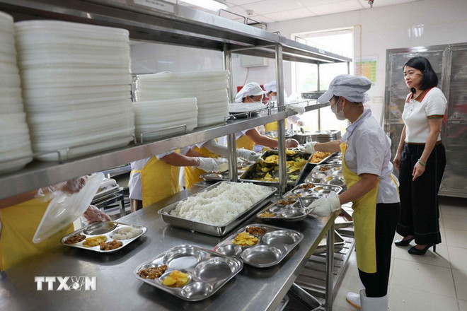 Chuẩn bị bữa ăn bán trú cho học sinh. (Ảnh: Thanh Tùng/TTXVN) 3.jpg
