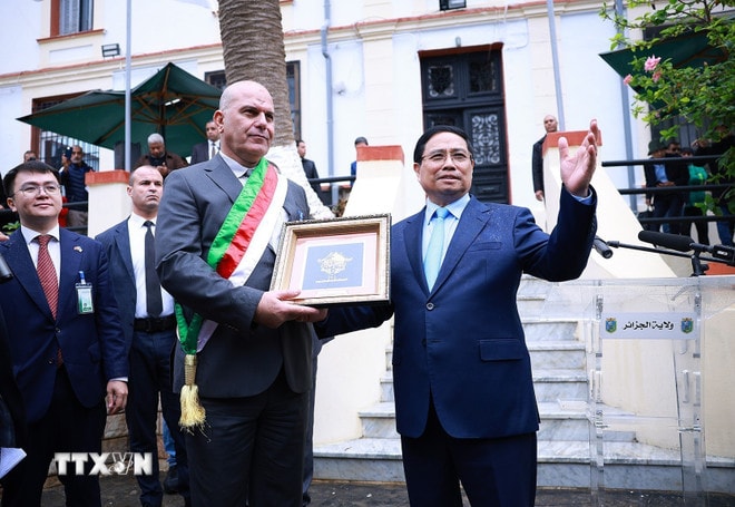 Thủ tướng Phạm Minh Chính tặng quà cho chính quyền địa phương, nơi đặt bia tưởng niệm về thân thế, sự nghiệp Chủ tịch Hồ Chí Minh ở Algeria. (Ảnh: Dương Giang/TTXVN) ttxvn-thu-tuong-du-le-khanh-thanh-bia-tuong-niem-ve-than-the-su-nghiep-chu-tich-ho-chi-minh-8422034-4.jpg
