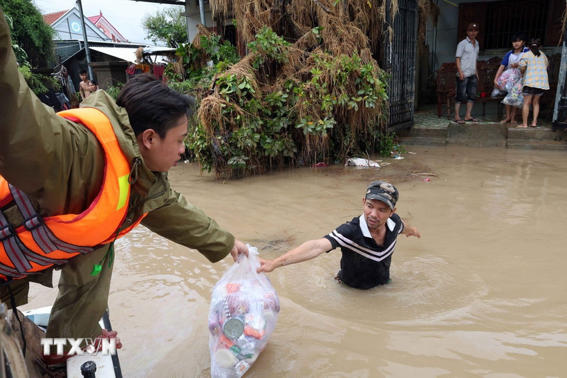 Lực lượng Công an tỉnh Đắk Lắk tiếp tế lương thực cho người dân ở vùng ngập sâu ven sông Bánh Lái. (Ảnh: Đỗ Trưởng/TTXVN)