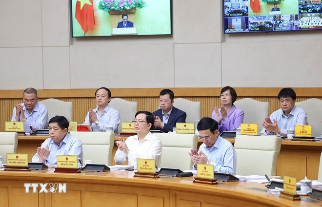 Thành viên Chính phủ và các đại biểu tham dự Phiên họp Chính phủ thường kỳ tháng 3/2026 và Hội nghị Chính phủ trực tuyến với địa phương. (Ảnh: Dương Giang/TTXVN) ttxvn-thu-tuong-chu-tri-phien-hop-chinh-phu-thuong-ky-thang-3-7.jpg