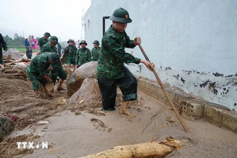 Các cán bộ, chiến sỹ tìm kiếm người mất tích trong lũ. (Ảnh: Nguyễn Oanh/TTXVN)