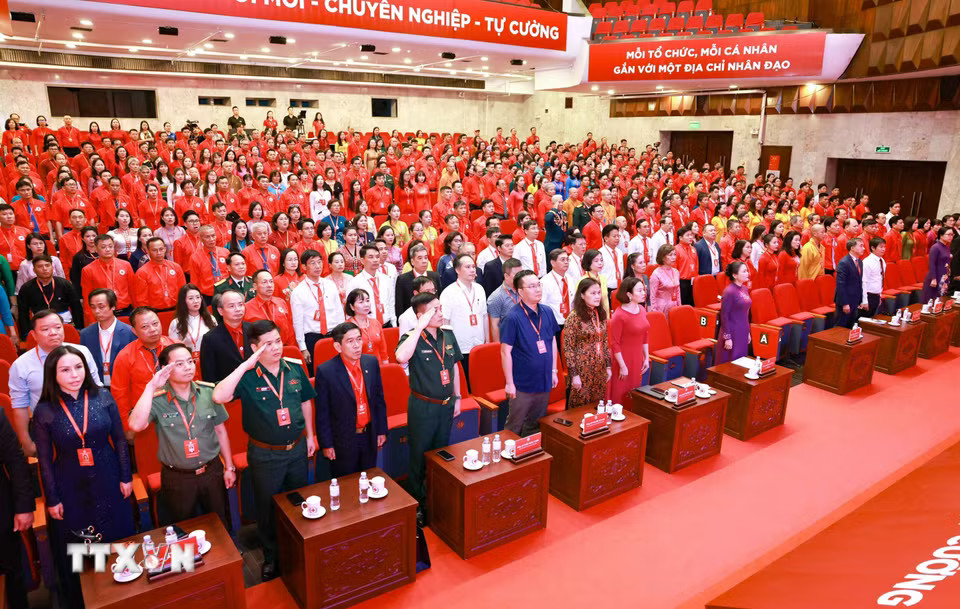 Đại biểu dự đại hội thực hiện nghi thức Chào cờ, hát Quốc ca. (Ảnh: Thanh Tùng/TTXVN)