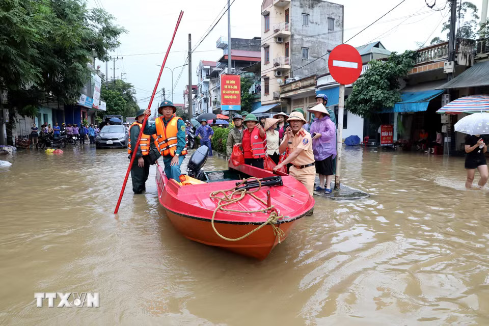 Lực lượng chức năng xã Thất Khê, tỉnh Lạng Sơn, thường trực tại các điểm ngập sâu trên Quốc lộ 4A để hỗ trợ nhân dân. (Ảnh: Văn Đạt/TTXVN)