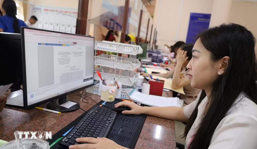 Cán bộ, công chức tại Ủy ban Nhân dân phường Chơn Thành, Đồng Nai làm việc ngoài giờ để bảo đảm giải quyết hồ sơ đúng hạn. (Ảnh: Đậu Tất Thành/TTXVN) ttxvn-can-bo-cong-chuc-tai-dong-nai-lam-viec-ngoai-gio-de-phuc-vu-nguoi-dan.jpg